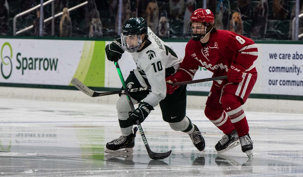 <p>Freshman forward A.J. Hodges (10) rushes to gain possession of the puck after the first puck drop of the game. The Badgers shut out the Spartans, 4-0, at Munn Ice Arena on March 5, 2021. </p>