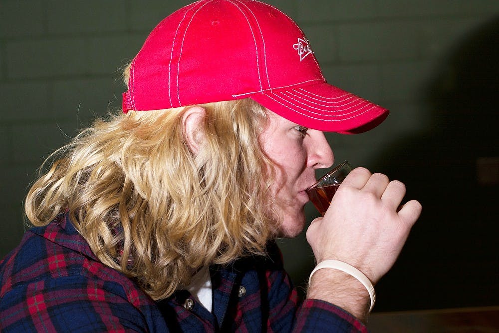 	<p>Biosystems engineering senior Jamie Burns samples cider at Red Cedar Spirits, 2000 Merritt Rd., on Feb. 6, 2014. The distillery has produced batches of vodka better than high-end commercial competitors, according to Red Cedar Spirits distiller Ari Sussman. Casey Hull/The State News</p>