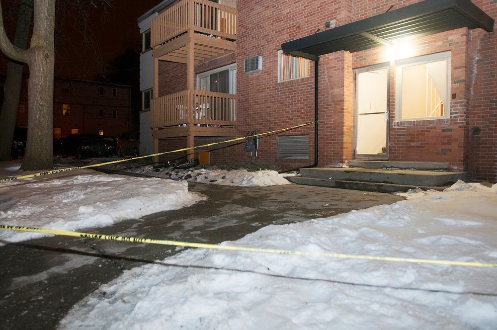 	<p>Police tape surrounds an apartment complex on the 200 block of Cedar street, Jan. 31, 2014.  Danyelle Morrow/The State News</p>