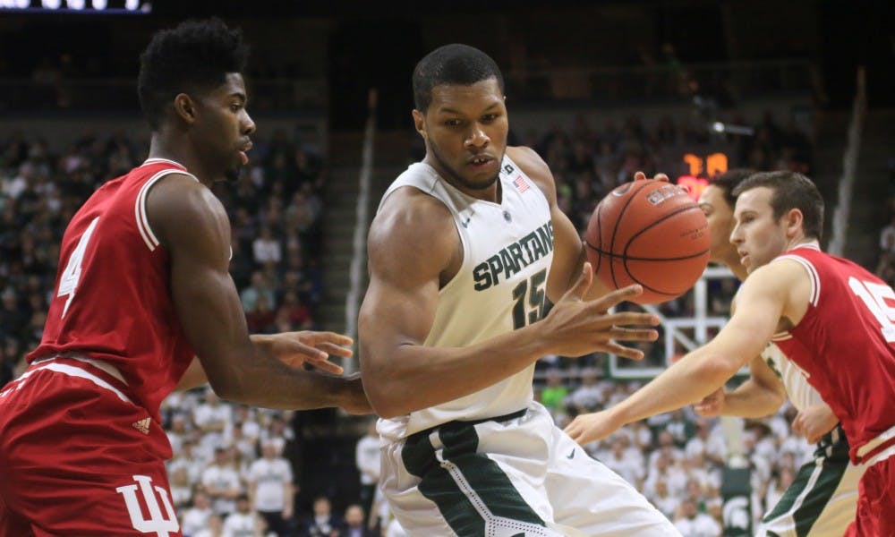 Sophomore forward Marvin Clark Jr., right, goes for a shot as Indiana guard Robert Johnson, left, defends him during the first half of the game against Indiana on Feb.14, 2016  at Breslin Center. The Spartans defeated the Indiana Hoosiers, 88-69.