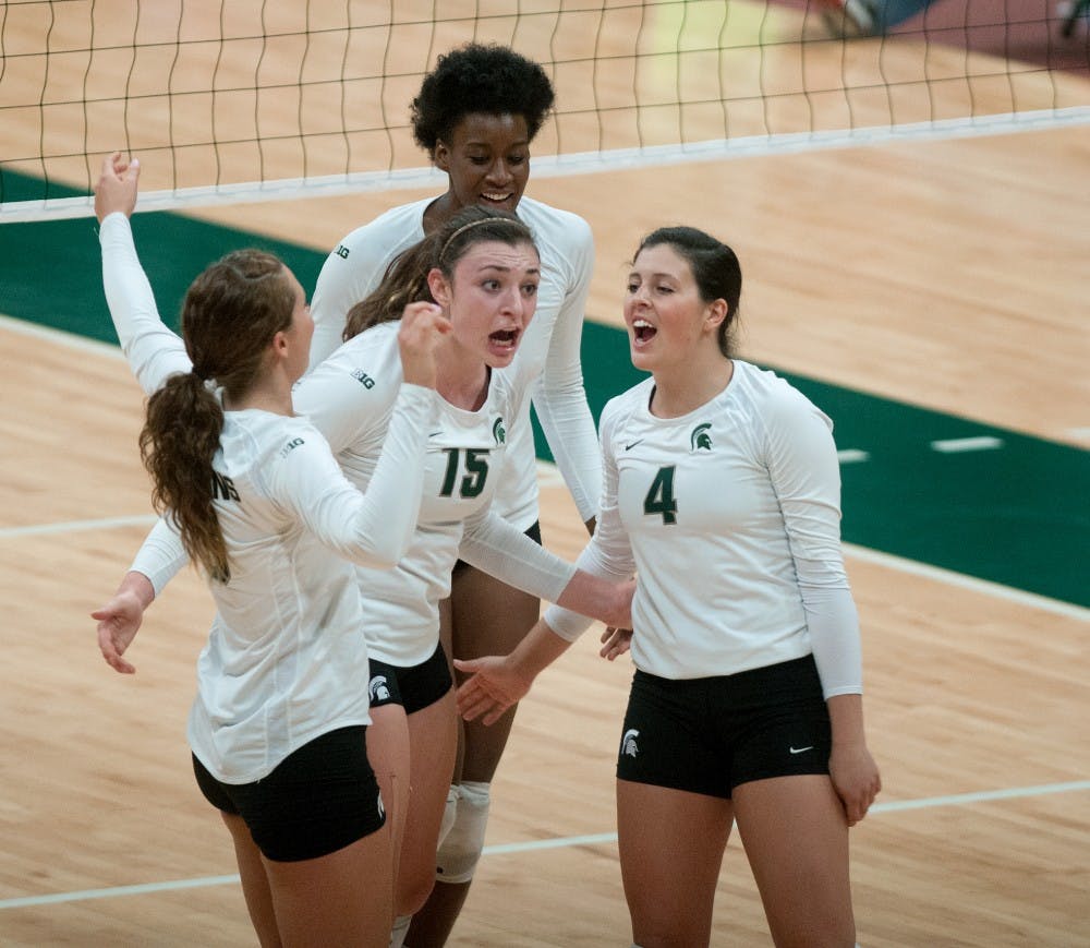 Junior outside hitter Lauren Wicinski, 15, and freshman setter Halle Peterson, 14, celebrate with teammates during the Ohio State volleyball game Saturday evening, Oct. 20, 2012 at the Jenison Fieldhouse. MSU lost the game, 3-1, and play again against Indiana on Friday, Oct. 26, 2012. Danyelle Morrow/The State News