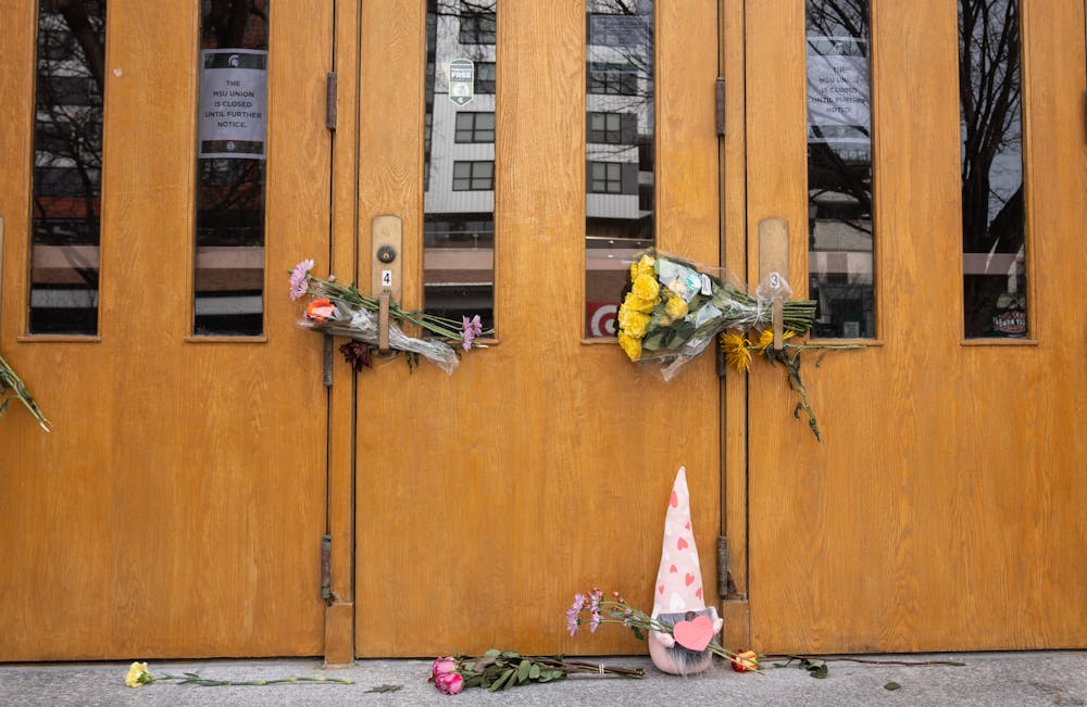 Flowers hang on the door of the Union on Feb. 20, 2023. The day before, 'Spartan Sunday' was held on campus where students and the community came together to take back the campus after a mass shooting took place on Feb. 13, 2023.