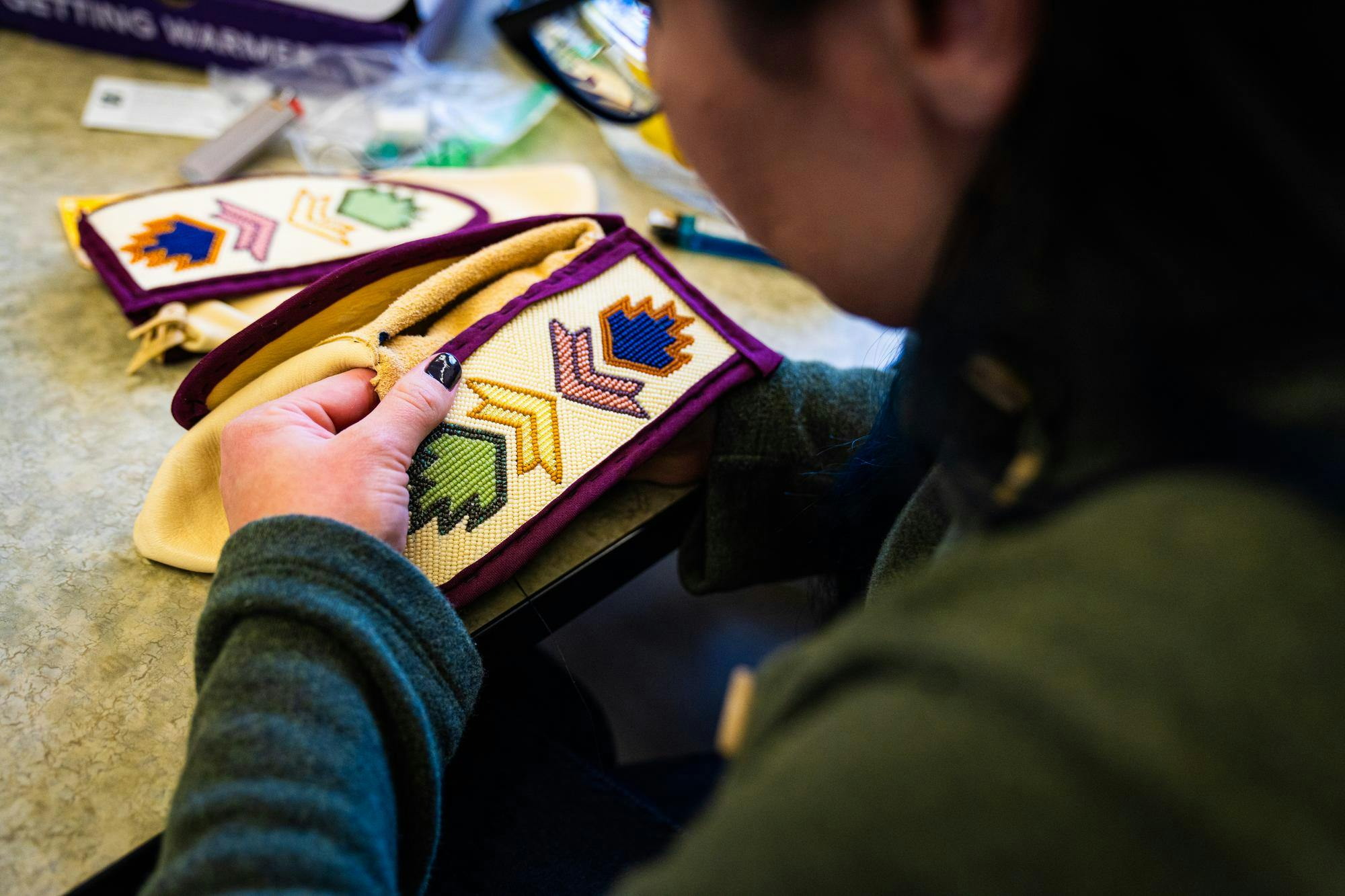 MSU American Indian and Indigenous Studies professor Blaire Morseau works on a project during a beading workshop held at the Urban Planning and Landscape Architecture building on Nov. 19, 2024.