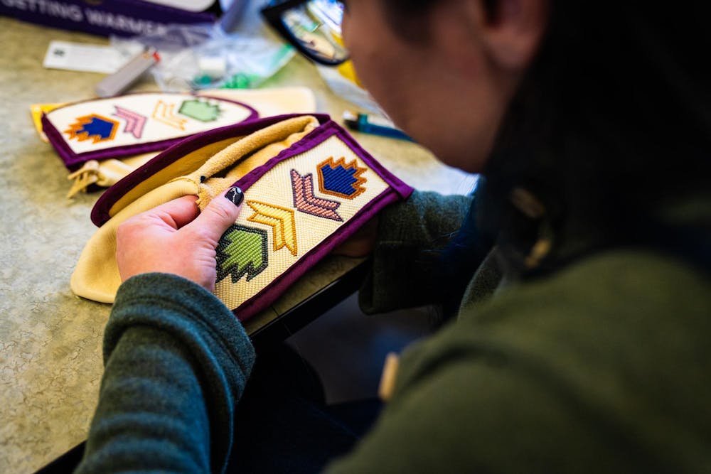 MSU American Indian and Indigenous Studies professor Blaire Morseau works on a project during a beading workshop held at the Urban Planning and Landscape Architecture building on Nov. 19, 2024.