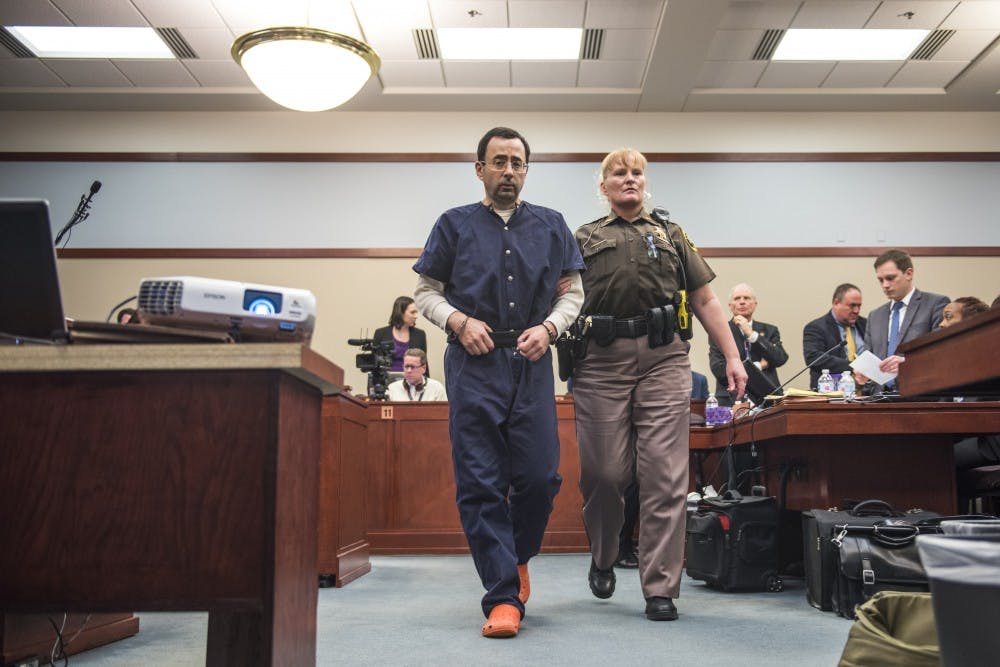 <p>Ex-MSU and USA Gymnastics doctor Larry Nassar is escorted out of the courtroom at the end of the sixth day of his sentencing on Jan. 23, 2018 at the Ingham County Circuit Court in Lansing. (Nic Antaya | The State News)</p>