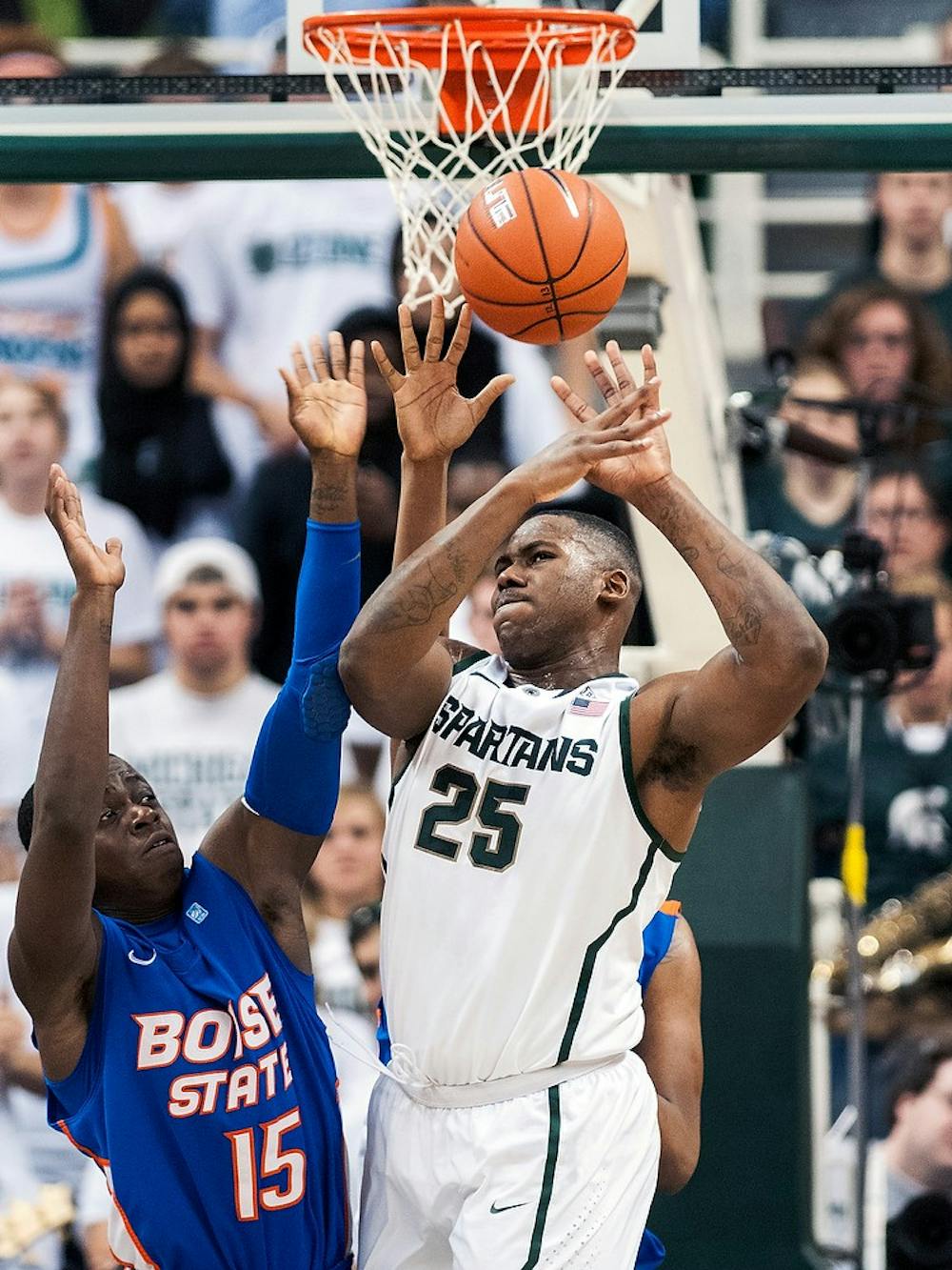 	<p>Senior center Derrick Nix battles with Boise State guard Thomas Bropleh for a rebound Nov. 20, 2012, at Breslin Center. The <span class="caps">MSU</span> basketball team defeated Boise State, 74-70, to improve the Spartan&#8217;s record to 3-1. Adam Toolin/The State News</p>