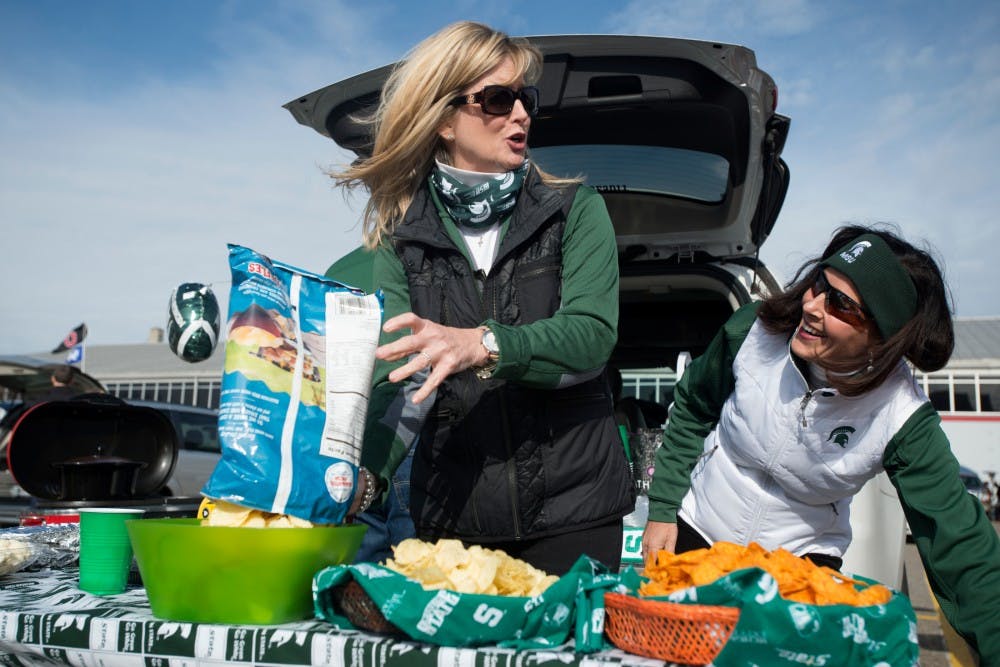 <p>Toledo, Ohio, resident Brenda Rafac, left, and Dublin, Ohio, resident Laurie Adolph, whose first cousin is Becky Dantonio, tailgates with friends on Nov. 21, 2015 outside Ohio Stadium in Columbus, Ohio before the OSU/MSU football game.</p>
