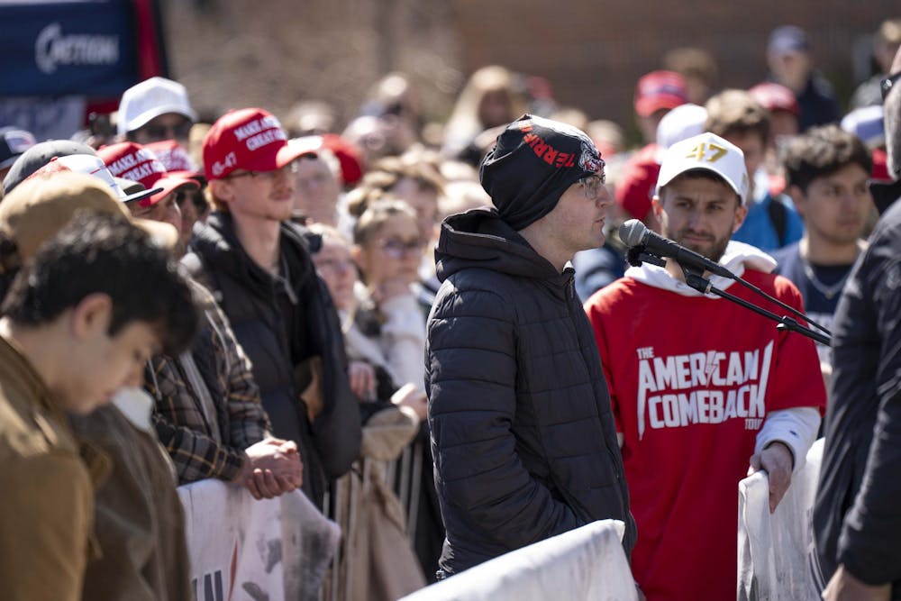 <p>An attendee of Charlie Kirk's "The American Comeback Tour" speaks at Wells Courtyard on April 11, 2025. The event, co-hosted by MSU's chapter of Turning Point USA, drew a crowd of both students and locals.</p>