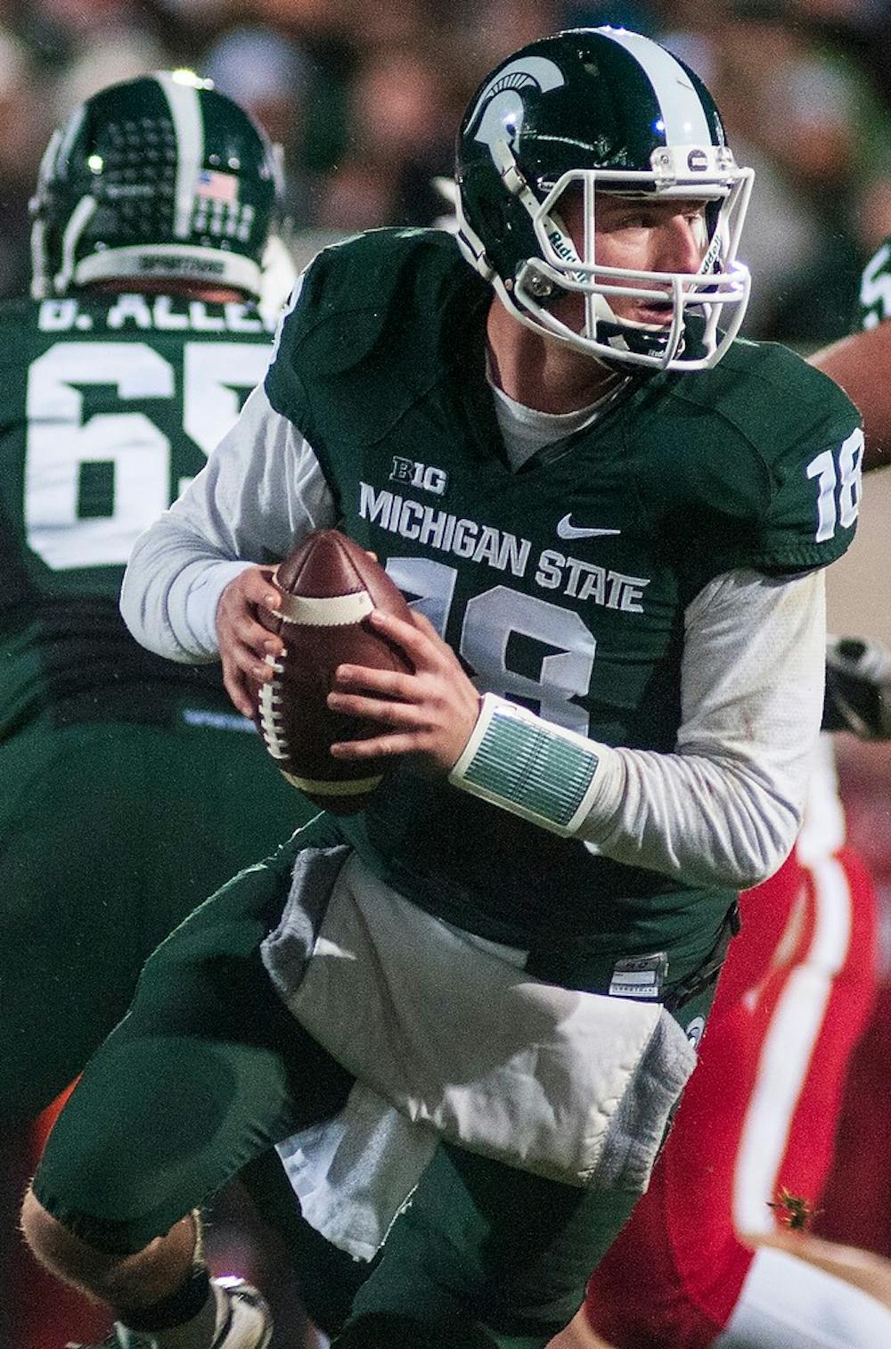 <p>Junior quarterback Connor Cook looks to make a pass Oct. 4, 2014, during the game against Nebraska at Spartan Stadium. The Spartans defeated the Cornhuskers, 27-22. Erin Hampton/The State News</p>