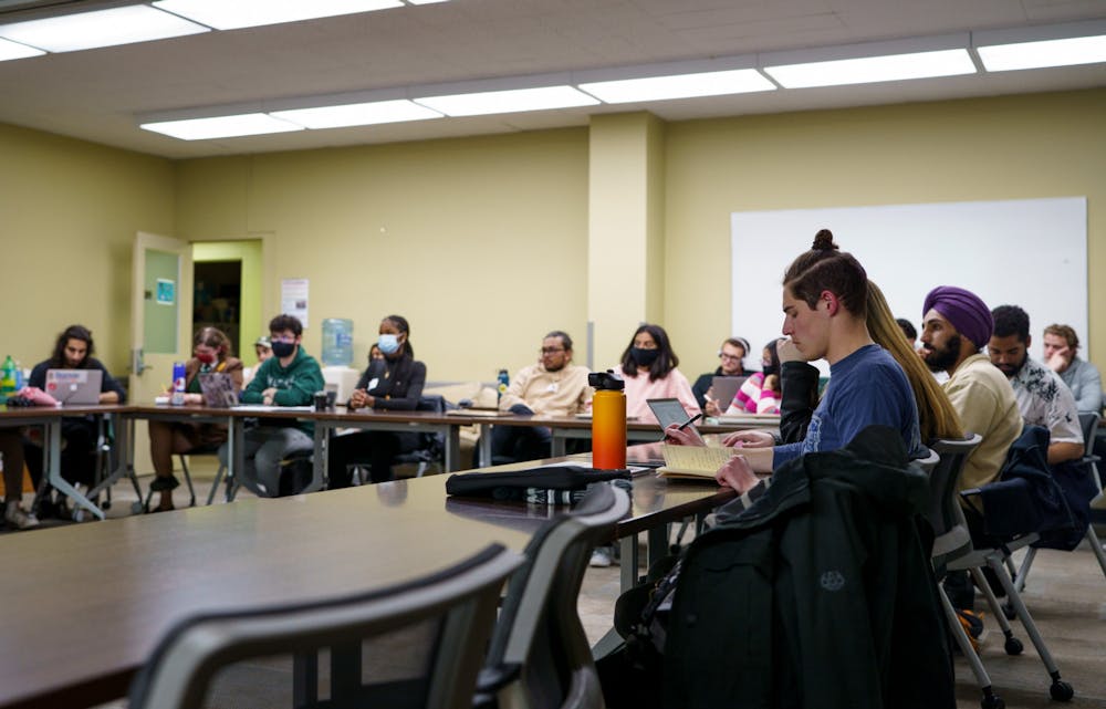 <p>Michigan State students spectate and take notes during the ASMSU Presidential debate in the Student Services Building Conference Room, on April 18, 2022.</p>