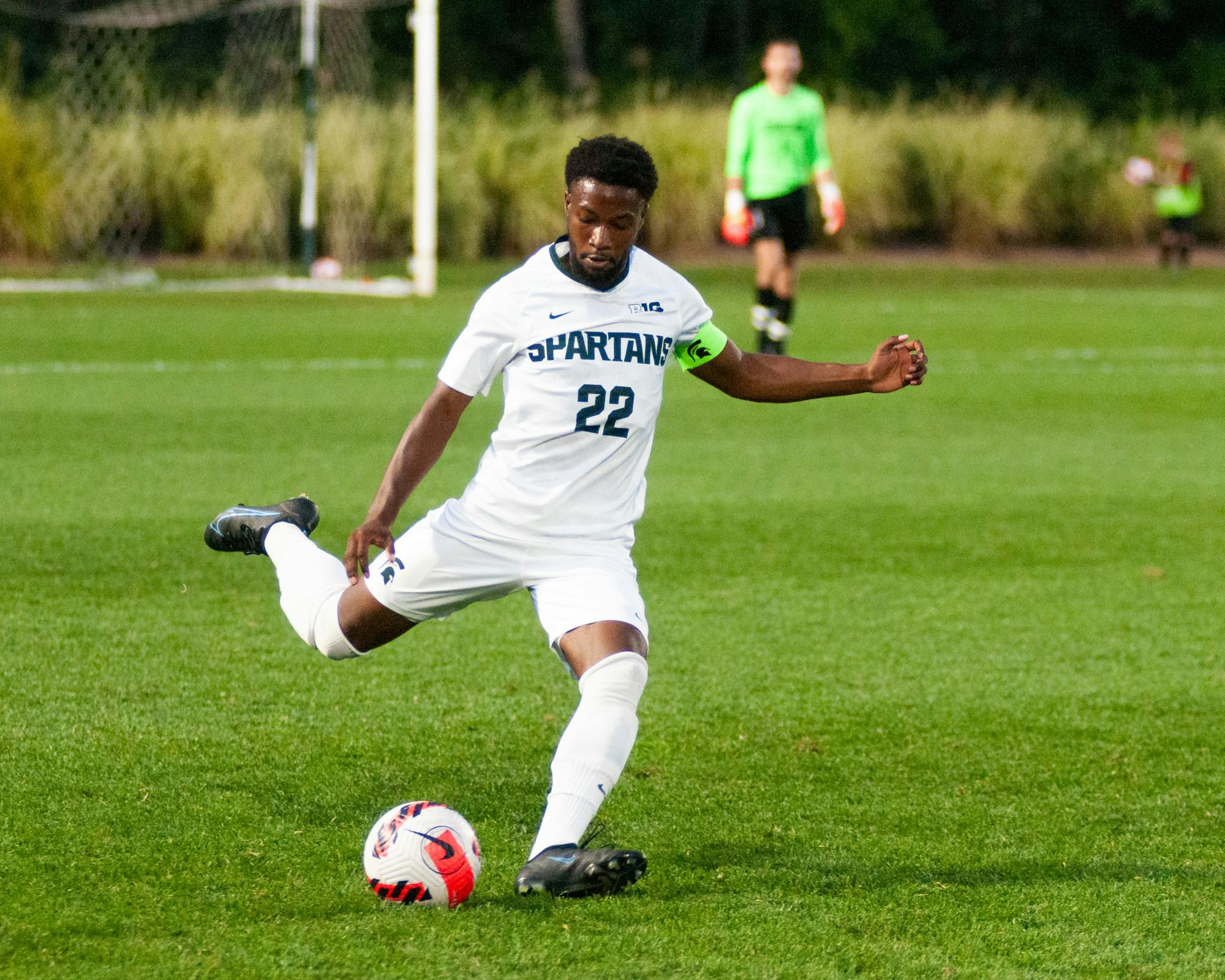 <p>Redshirt junior defender Will Perkins kicking the ball downfield. </p>