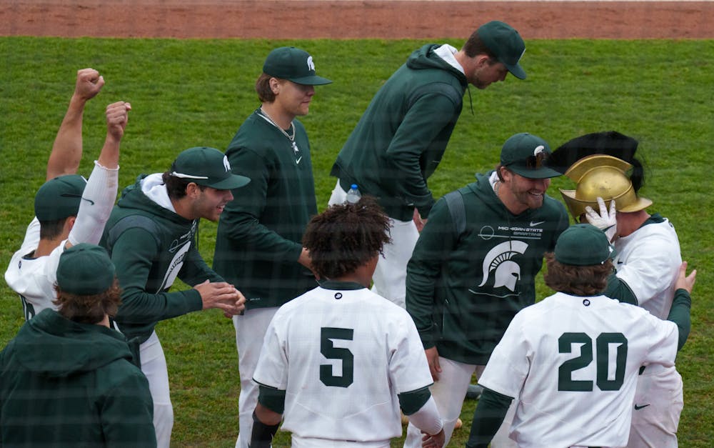 <p>Michigan State sophomore Jack Frank celebrates with his team as well as putting on the Spartan helmet after hitting a home run at McLane Baseball Stadium, on March 30, 2022. Spartans are victorious 12-5 against Youngtown State.</p>