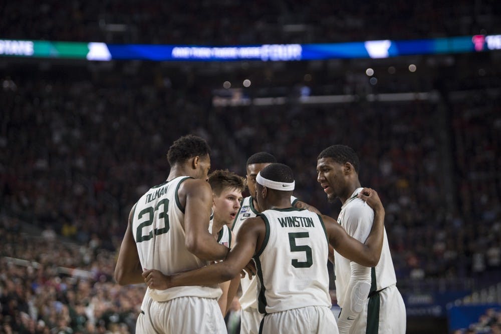 The Spartans huddle during the first half of the NCAA Final Four game against Texas Tech at U.S. Bank Stadium in Minneapolis on April 6, 2019. (Nic Antaya/The State News)