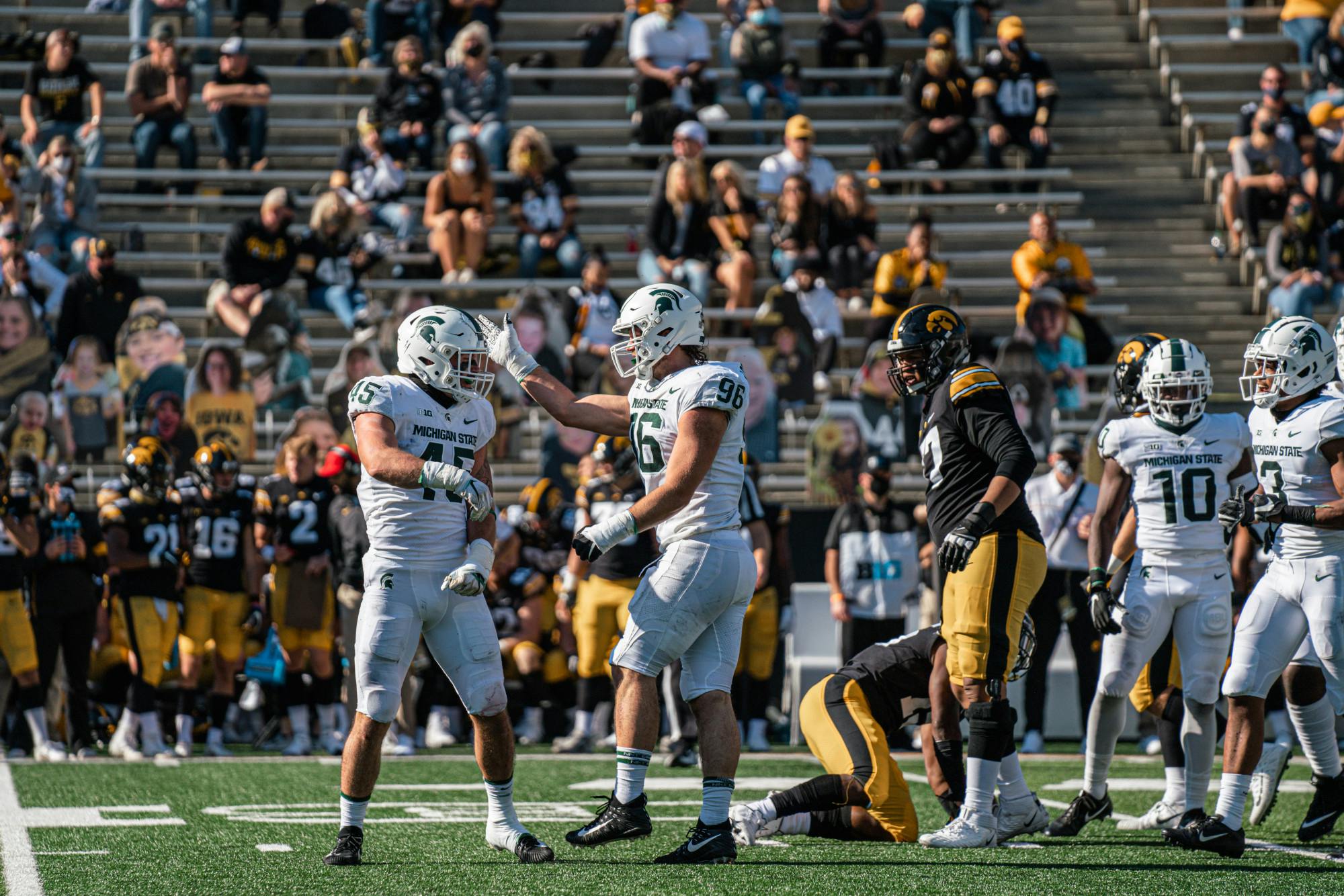 <p>Noah Harvey (No. 45) and Jacub Panasiuk (No. 96) celebrate after a play is blown dead against Iowa on Nov. 7, 2020.</p>