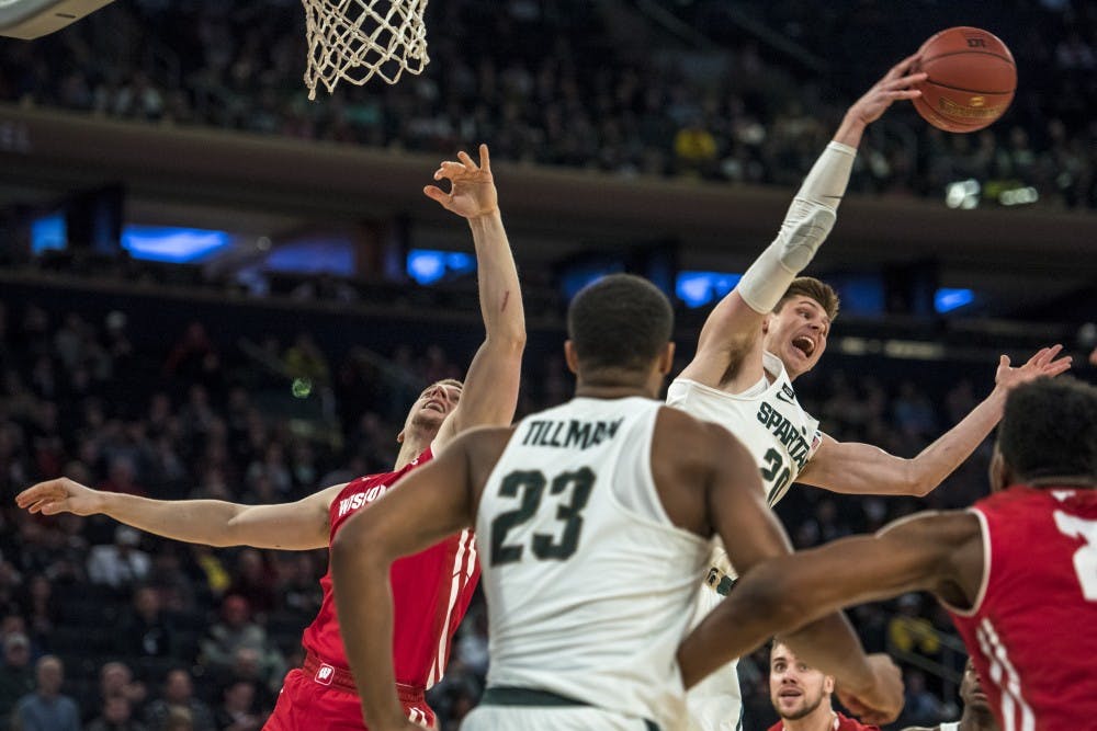 Junior guard Matt McQuaid (20) throws the ball to a teammate during the 2018 Big Ten Men's Basketball quarterfinal game between MSU and Wisconsin on March 2, 2018 at Madison Square Garden in New York. (Nic Antaya | The State News)