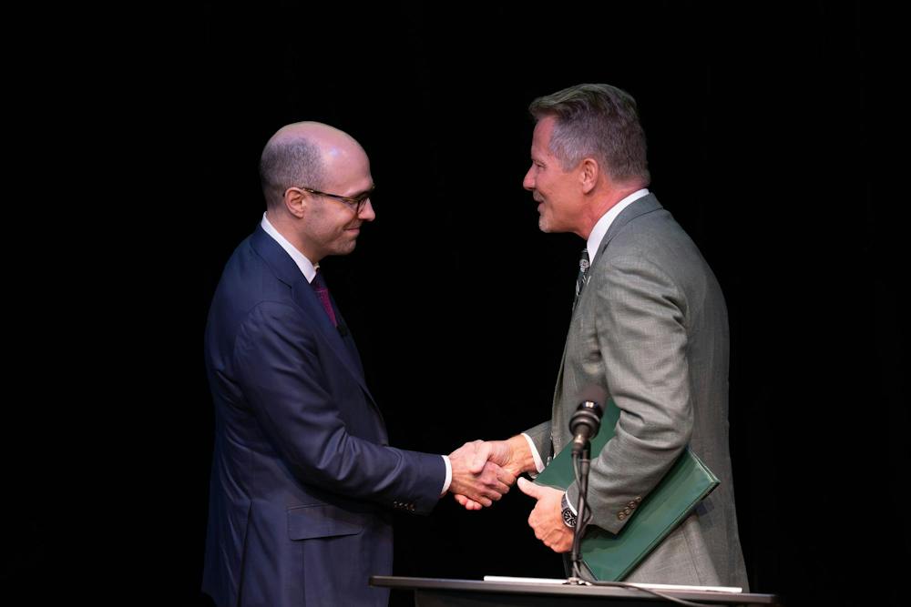 <p>A.G. Sulzberger, chairperson and publisher of The New York Times (left), shakes hands with Michigan State University president Kevin M. Guskiewicz (right), during the Presidential Speaker Series at the Wharton Center Pasant Theatre in East Lansing, Mich., on Tuesday, Sept. 29, 2026. The New York Times is marking its 175th anniversary in 2026.</p>
