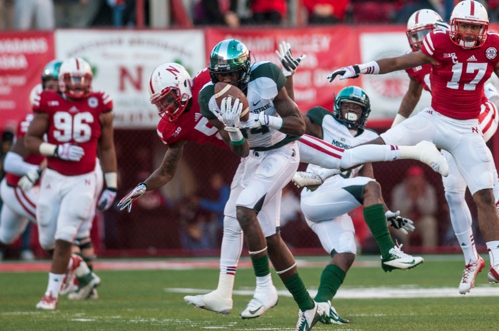 	<p>Junior wide receiver Tony Lippett makes a catch during the game against Nebraska on Nov. 16, 2013, at Memorial Stadium in Lincoln, Neb. The Spartans defeated the Cornhuskers, 41-28. Khoa Nguyen/The State News</p>