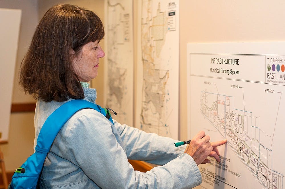 	<p>East Lansing resident Irene Cahill marks one of the many maps Oct. 14, 2013, at the Bigger Picture Comprehensive Plan meeting at the Hannah Community Center. The group invited members of the community to listen to presentations and give their feedback about what is going on around East Lansing. Margaux Forster/The State News</p>