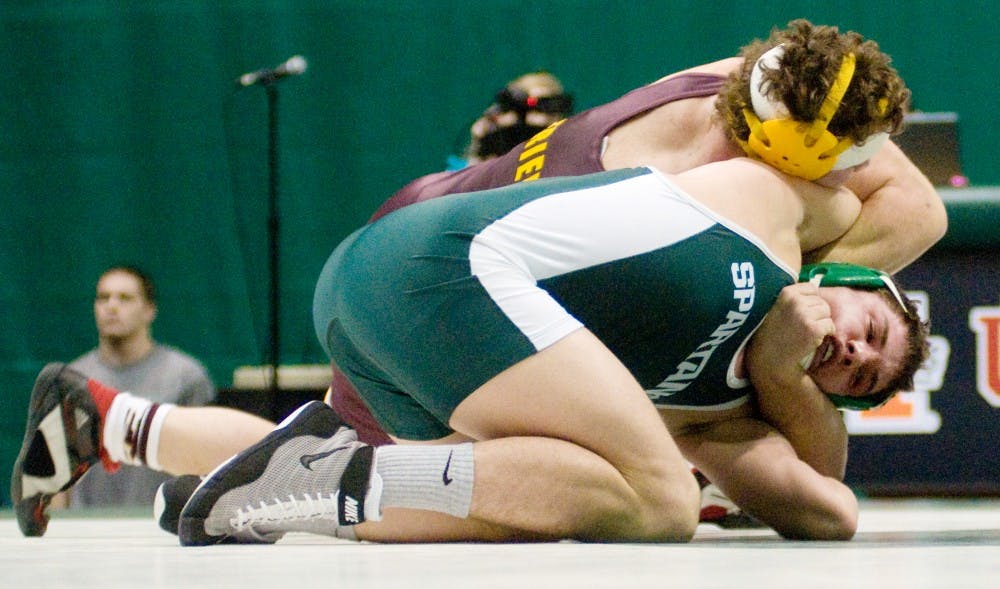 Junior Ian Hinton wrestles with Central Michigan junior Chad Friend Friday at Jenison Field House.  Hinton defeated Friend, 7-3.  Katy Joe DeSantis/The State News