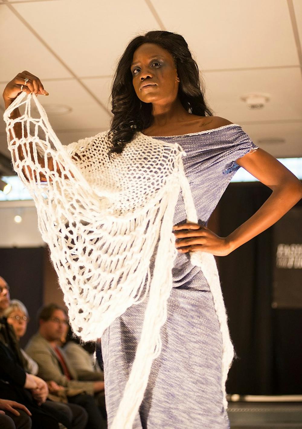 <p>A model walks down the runway Saturday during the "Fashion for the Fire" fashion show at the Runway in downtown Lansing on S. Washington Square. The show's purpose is to raise proceeds to provide healing services to children who have survived sexual trauma in the community. Hannah Levy/The State News</p>