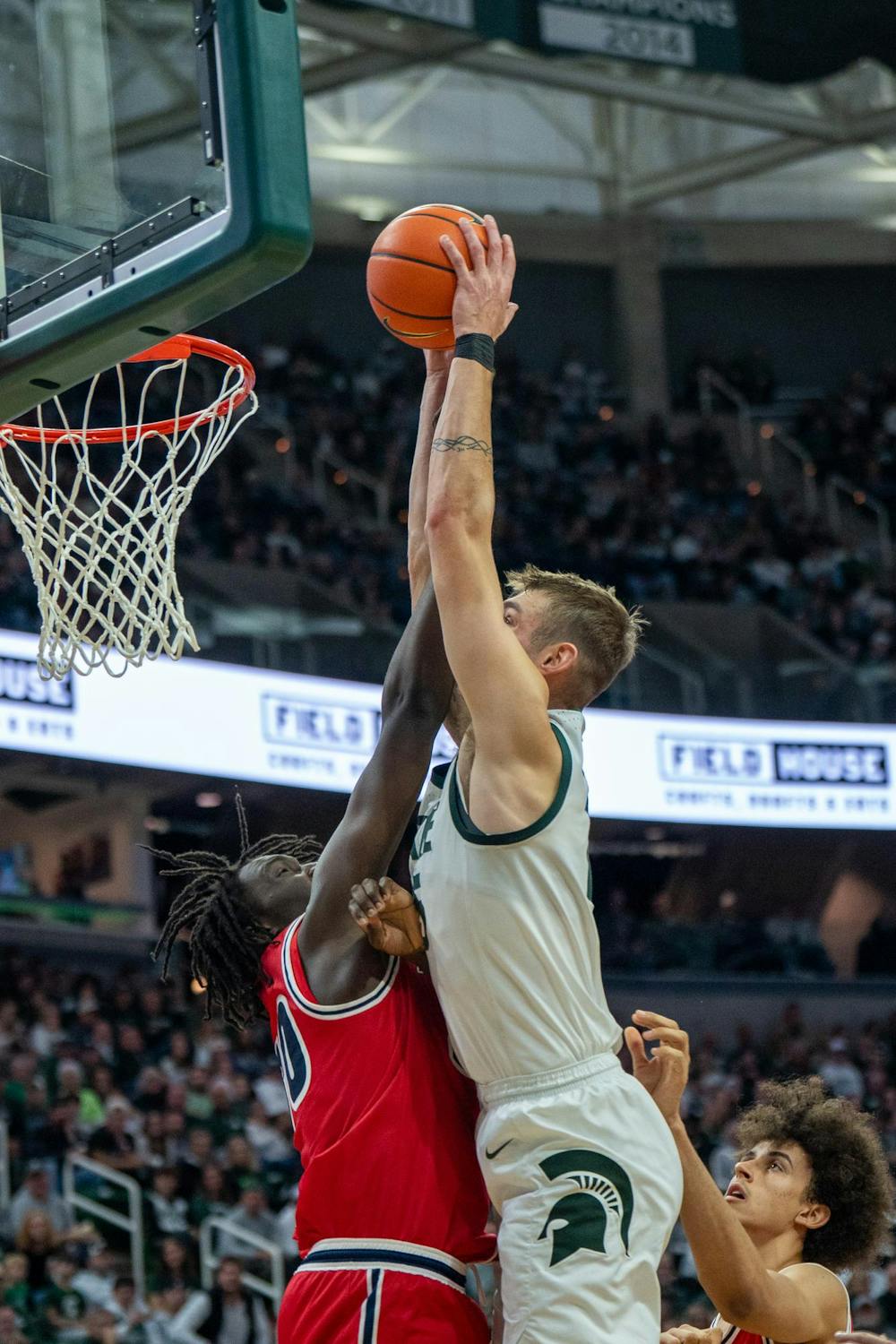 Michigan State center Carson Cooper (15) goes for a dunk during Michigan State’s game against Detroit Mercy at Breslin Center in East Lansing, Mich., on Friday, Nov. 21, 2025.