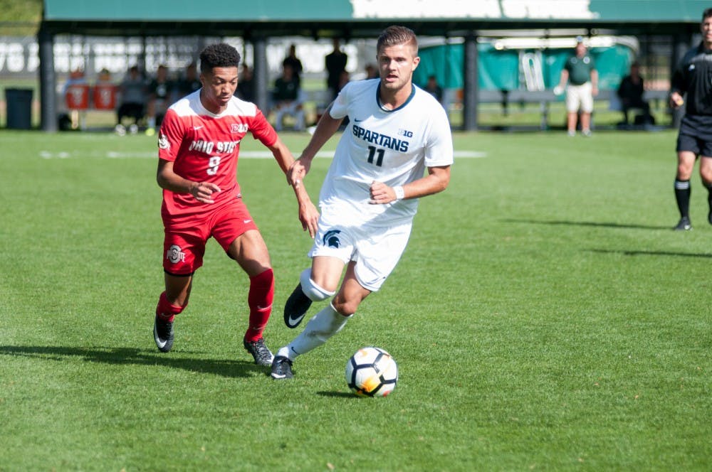 Junior forward Ryan Sierakowski runs away from a defender during the game against Ohio State, on Oct. 1, at DeMartin Stadium at Old College Field. The Spartans defeated the Buckeyes, 5-1.