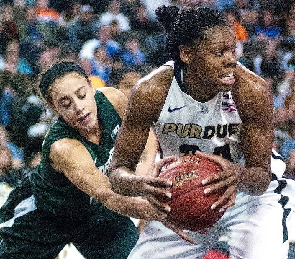 Purdue forward Drey Mingo grabs a rebound against junior guard Klarissa Bell during the Big Ten Tournament championship game at Sears Centre in Hoffman Estates, Ill. The Spartans lost to the Boilermakers 62-47. Julia Nagy/The State News