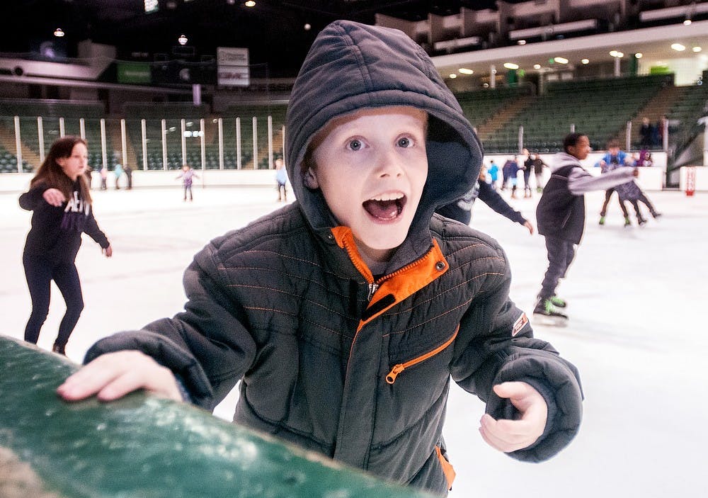 	<p>Owen Bozsik, 10, of Lansing holds onto the boards as he skates on the ice Friday, March 22, 2013, at Munn Ice Arena. Project Green and White held the event for 170 Lewton Elementary School children to enjoy a day of ice skating. Adam Toolin/The State News</p>