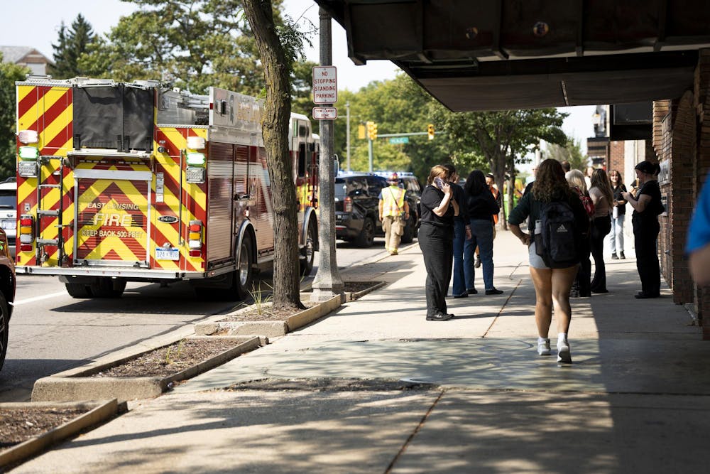 Onlookers gather around on Grand River to observe the aftermath of an accident.  