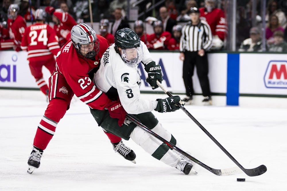 <p>MSU junior defense Maxim Štrbák (8) tries to keep the puck away from OSU senior forward Davis Burnside (23) in the Munn Ice Arena on March 14, 2026. Ohio State defeated Michigan State 3-2 in overtime.</p>