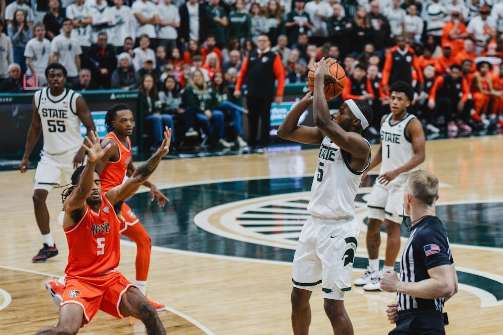 <p>MSU junior guard Tre Holloman (5) takes a three point shot against Bowling Green at the Breslin Center on Nov. 16, 2024</p>