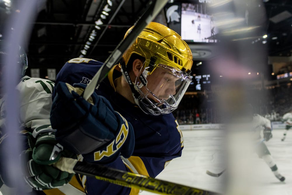 <p>Notre Dame defenseman Nick Leivermann fights in the corner for the puck. The Spartans were defeated by the Fighting Irish, 2-1, at Munn Ice Arena on November 22, 2019. </p>