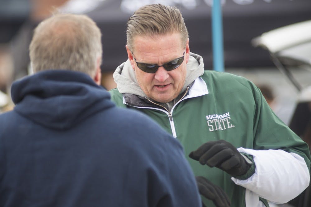 <p>White Hall, Mich. resident Mark Zickel, right, speaks with longtime friend and Cincinnati, OH resident John Harder on Oct. 17, 2015, prior to the game against Michigan at Michigan Stadium in Ann Arbor. Hundreds of Spartans flocked to Ann Arbor to support the Spartans at the rivalry game. </p>