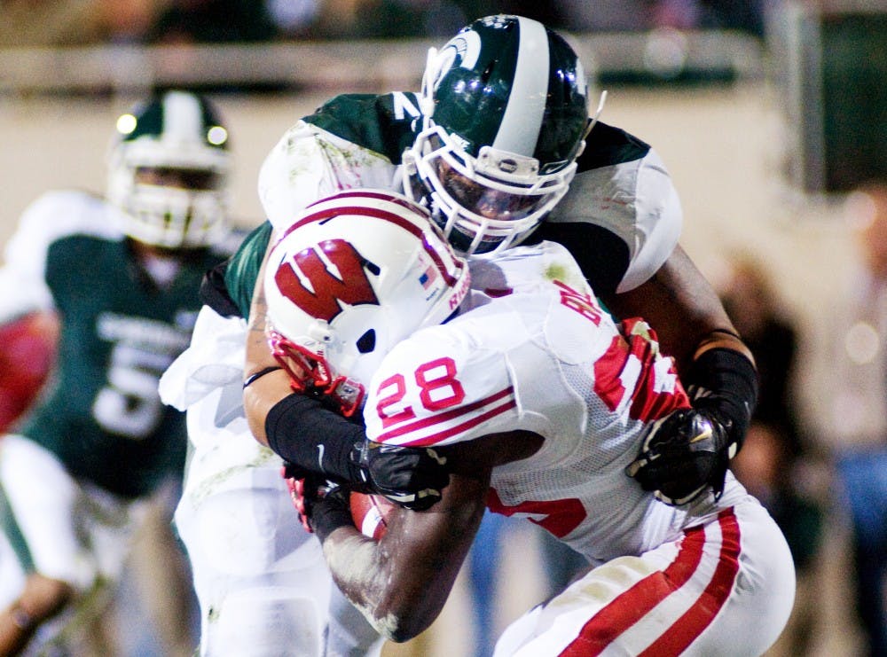 Junior defensive tackle Jerel Worthy stops Wisconsin running back Montee Ball on the two yard line Saturday at Spartan Stadium. The Spartans defeated the Wisconsin Badgers 37-31. Matt Radick/The State News