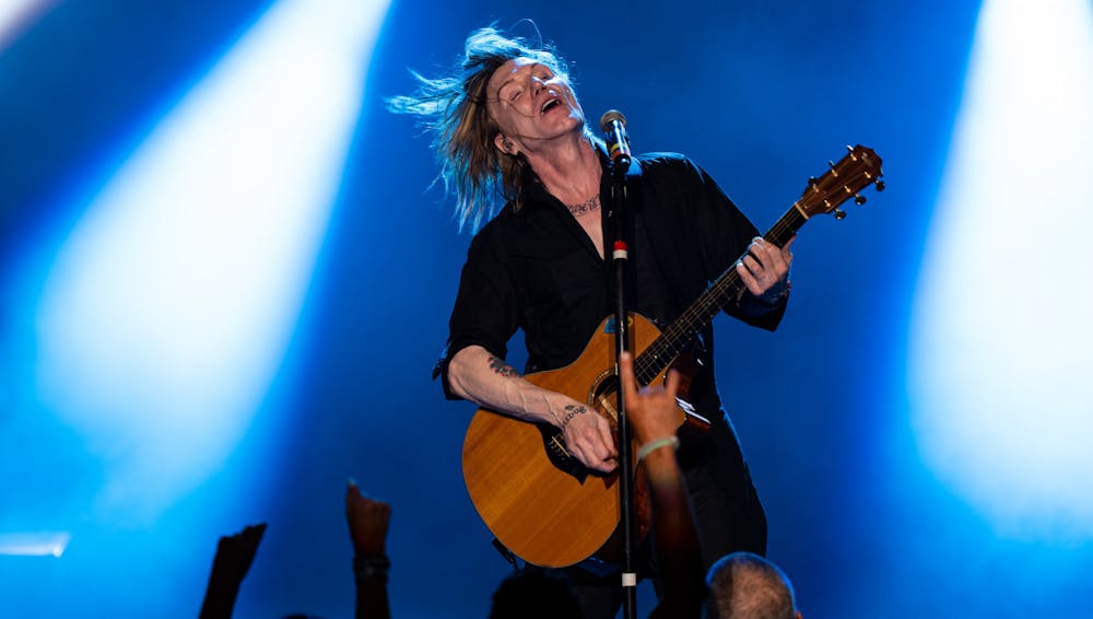 John Rzeznik flips his hair during the Goo Goo Dolls' concert at the Michigan Lottery Ampitheatre in Stearling Heights on Aug. 7, 2022.