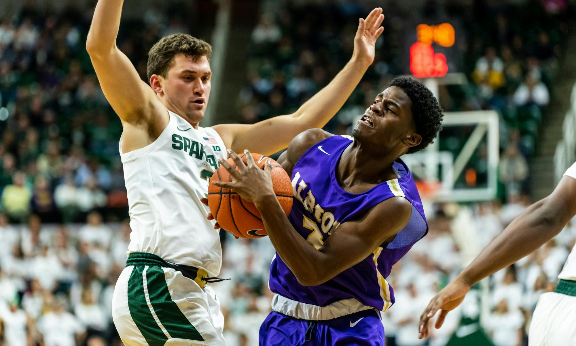 <p>Then-sophomore guard Foster Loyer (left) defends Albion guard Cortez Garland (right). The Spartans defeated the Britons, 85-50, at the Breslin Student Events Center on Oct. 29, 2019. </p>