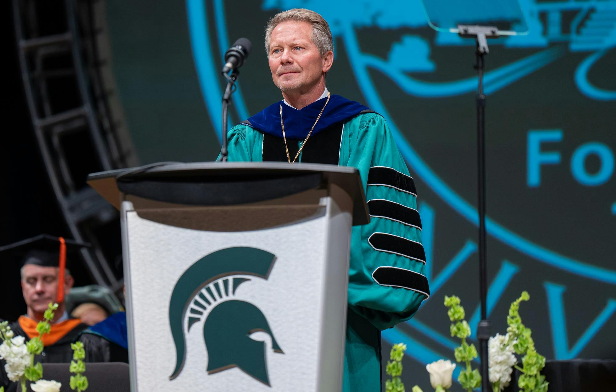 <p>MSU President Guskiewicz watches as Pro-Palestinian activists interrupt his speech to call for divestment during the Presidential Investiture on Sept. 29, 2024, in Cobb Hall at the Wharton Center. The investiture celebrated the new leader and formally bestowed the authority of the office.</p>