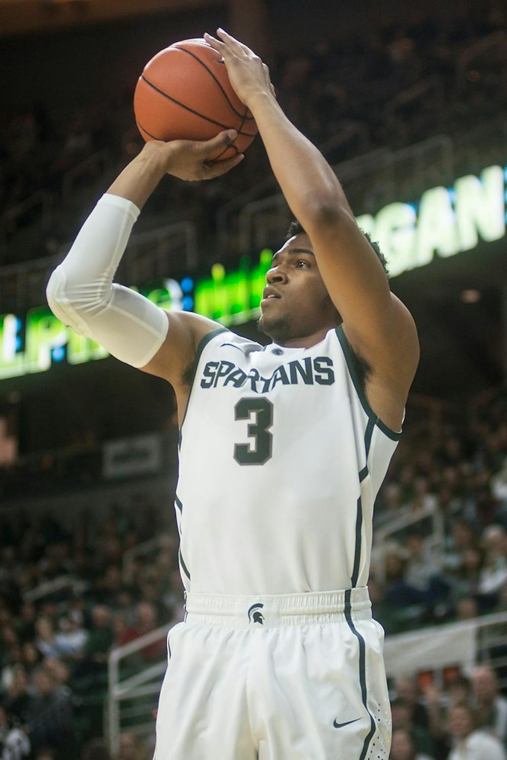 <p>Sophomore guard Alvin Ellis lll attmpts a point Dec. 14, 2014, during a game against Oakland at Breslin Center. The Spartans defeated the Golden Grizzlies, 87-61. Erin Hampton/The State News</p>
