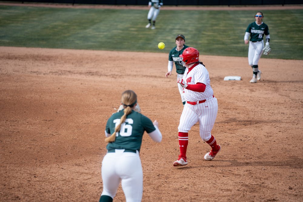 <p>First Baseman Collette Allen and shortstop Anna Fox catch a player into a pickle and gets her out during the first series game against Wisconsin on March 24, 2023, at Secchia Softball Stadium.</p>