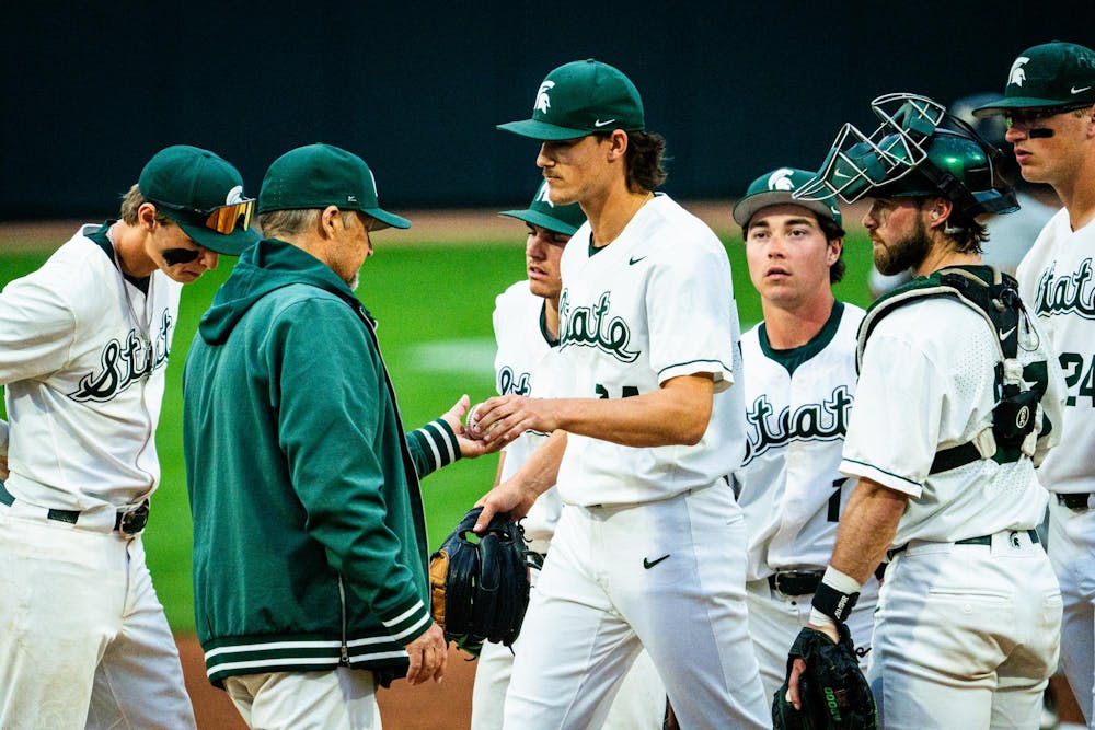 MSU sophomore pitcher Logan Pikur (34) hands the ball to pitching coach Mark Van Ameyde while exiting the mound during a game at McLane Stadium on April 13, 2025.