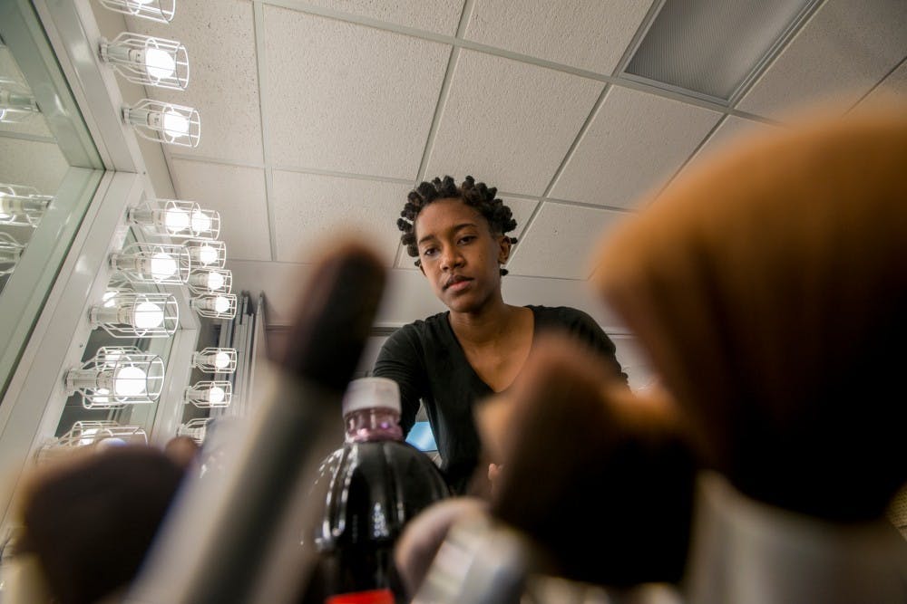 <p>Theatre junior Camille Thomas looks through make up supplies in preparation for a run through of the Haunted Auditorium on Oct. 27, 2016 at the Auditorium.</p>