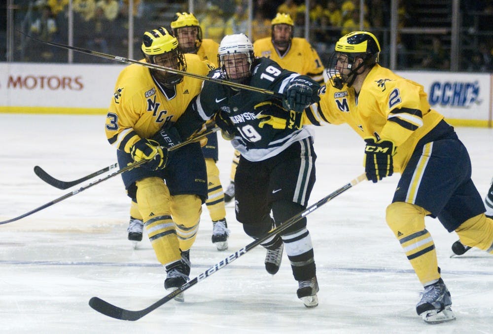 Senior center Joey Shean struggles to get out from behind Michigan opponents Saturday at Yost Ice Arena in Ann Arbor. MSU lost to U-M, 4-0, splitting their weekend series, 1-1. Kat Petersen/The State News