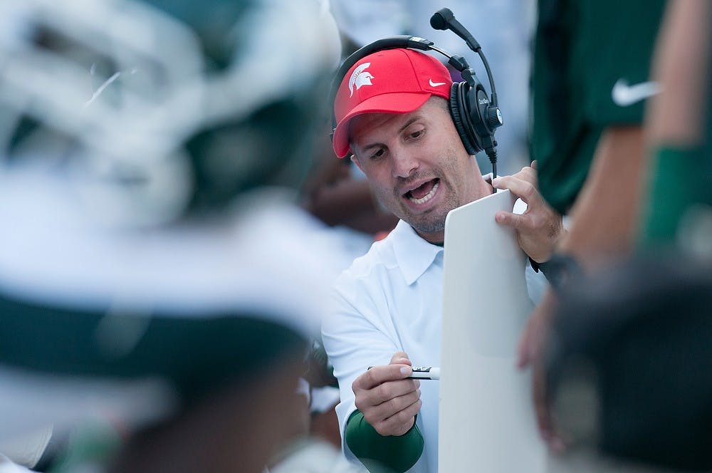 	<p>Linebackers/special teams coach Mike Tressel works through a play Sept. 14, 2013, at Spartan Stadium. The Spartans defeated Youngstown State, 55-17. Julia Nagy/The State News</p>