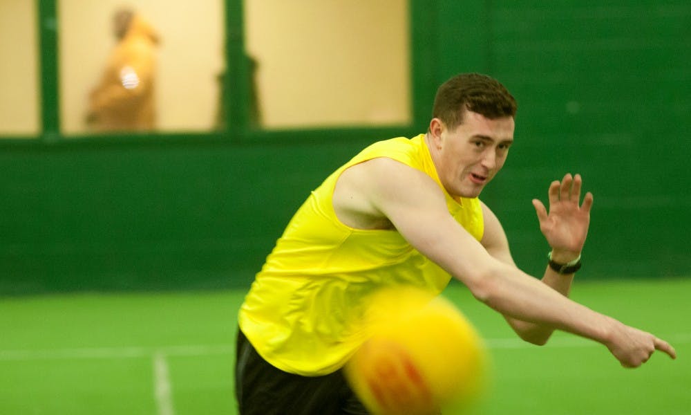 Senior supply chain management Reece Adams throws a ballon Feb. 26, 2016 at IM west. The game was a charity event to raise money for the city of Flint. 