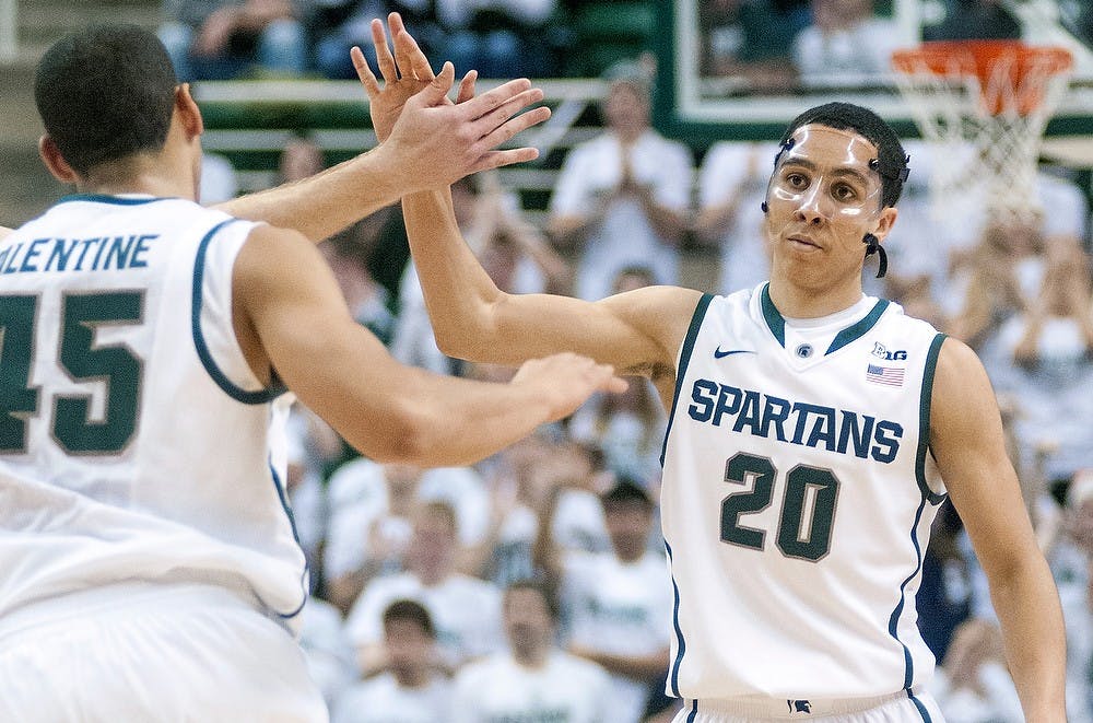 	<p>Teammates celebrate sophomore guard Travis Trice&#8217;s three-point field goal. Trice made four of them in the game. The Spartans defeated Arkansas-Pine Bluff 76-44 Wednesday, Dec. 5, 2012, at Breslin Center. Justin Wan/The State News</p>