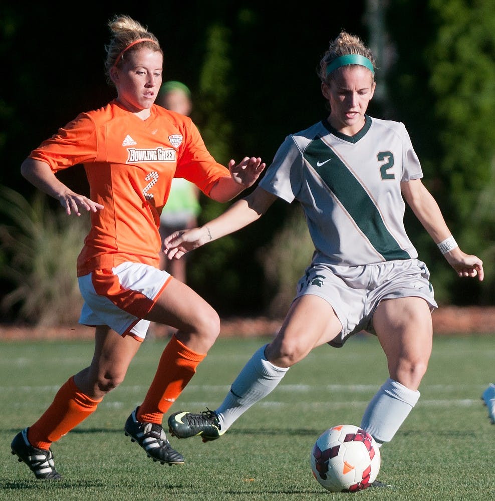 	<p>Sophomore forward Allyson Krause prepares to pass the ball while Bowling Green midfielder Ashley Garr tries block the pass during the game on Sept. 13, 2013 at DeMartin Stadium at Old College Field. The Spartans defeated the Falcons, 3-1. Georgina De Moya/The State News</p>