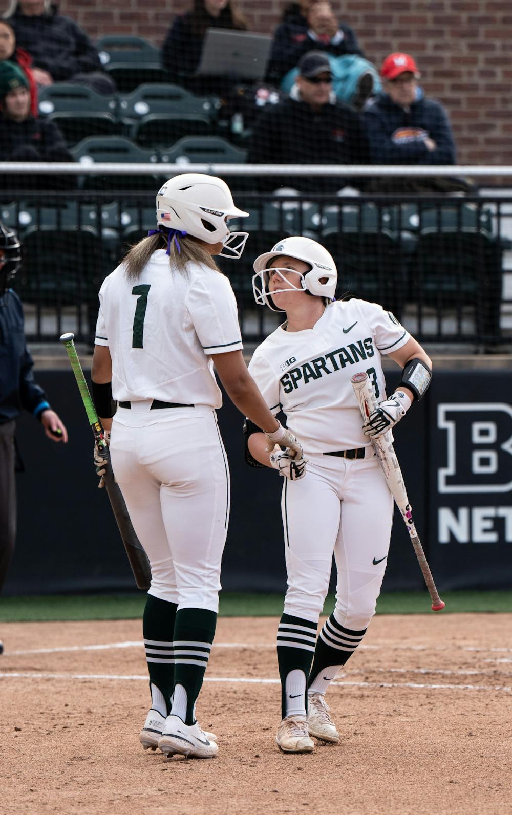 <p>Senior Courtney Callahan talks to teammate Camryn Wincher before Wincher steps up to bat during the matchup on April 29th, 2022. </p>