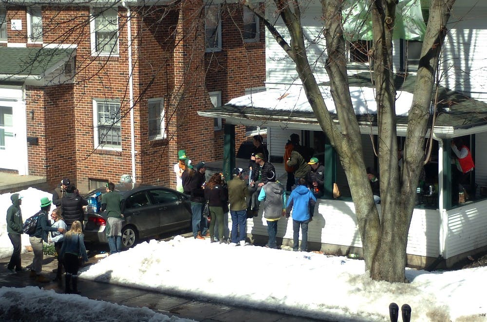 <p>Students celebrate St. Patrick's Day with at a house party on March 17, 2014, on Albert Ave. Despite classes many students attended parties and started drinking at bars early in the morning. Erik Sargent/The State News</p>