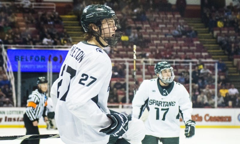 <p>Sophomore wingman Mason Appleton (27) celebrates after scoring a goal during the second period of the 52nd Annual Great Lakes Invitational semifinal game against Western Michigan on Dec. 29, 2016 at Joe Louis Arena in Detroit. The Spartans were defeated by the Broncos, 4-1.</p>