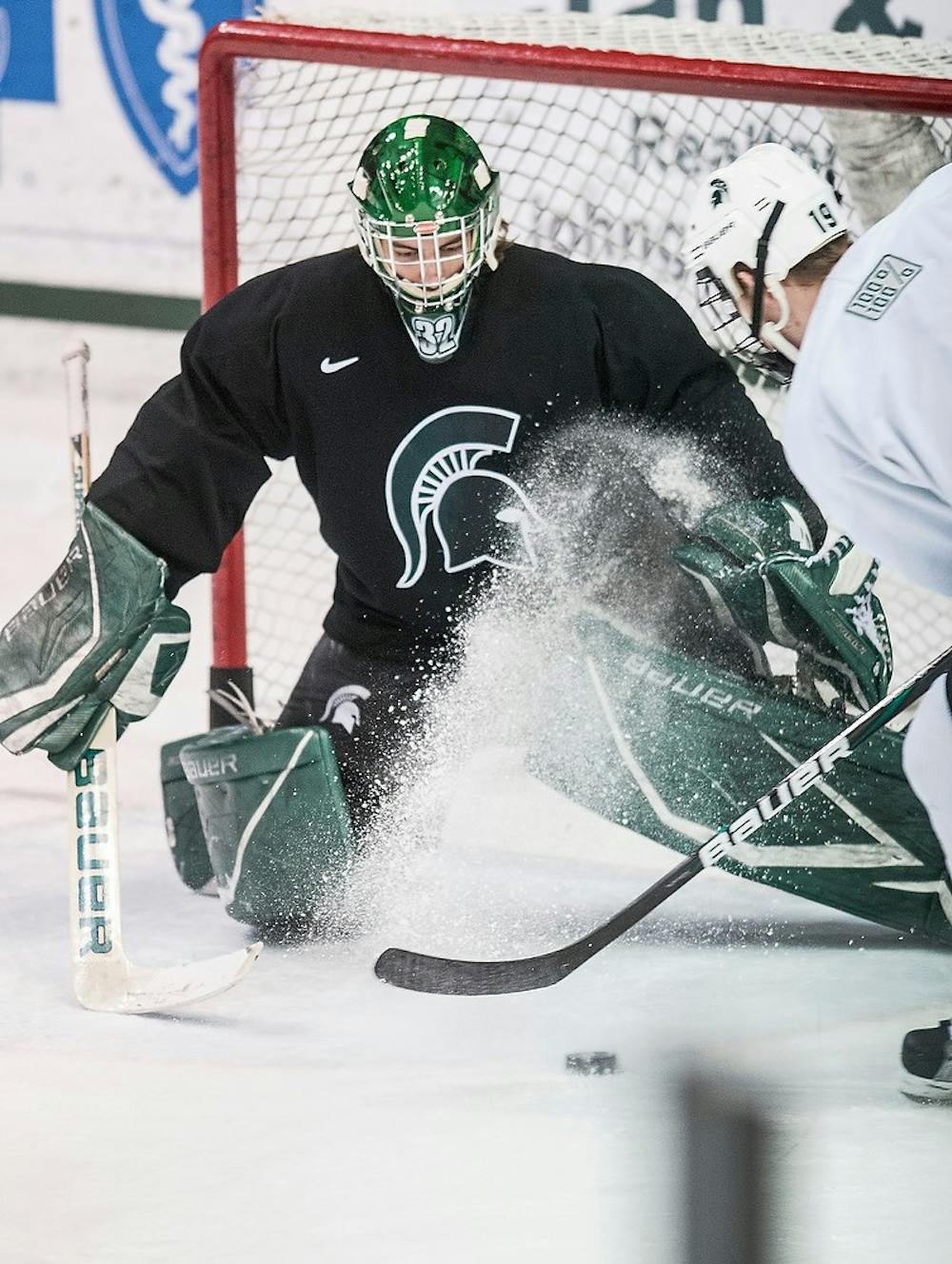 	<p>Sophomore goaltender Nathan Phillips defends the net against teammate and freshman forward Matt DeBlouw&#8217;s goal attempt during a skills competition portion of hockey practice Feb. 11, 2013, at Munn Ice Arena. The skills competition pitted <span class="caps">MSU</span> players against one another in slap shots, accuracy and puck speed. Danyelle Morrow/The State News</p>